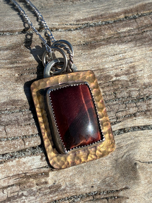 Handmade Red Tiger’s Eye and hammered copper pendant necklace in sunlight