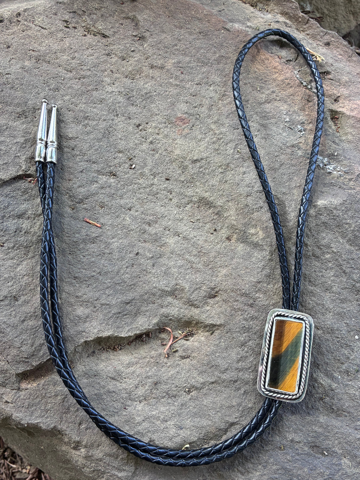 Handmade Tiger’s Eye bolo tie with sterling silver setting and black braided cord
