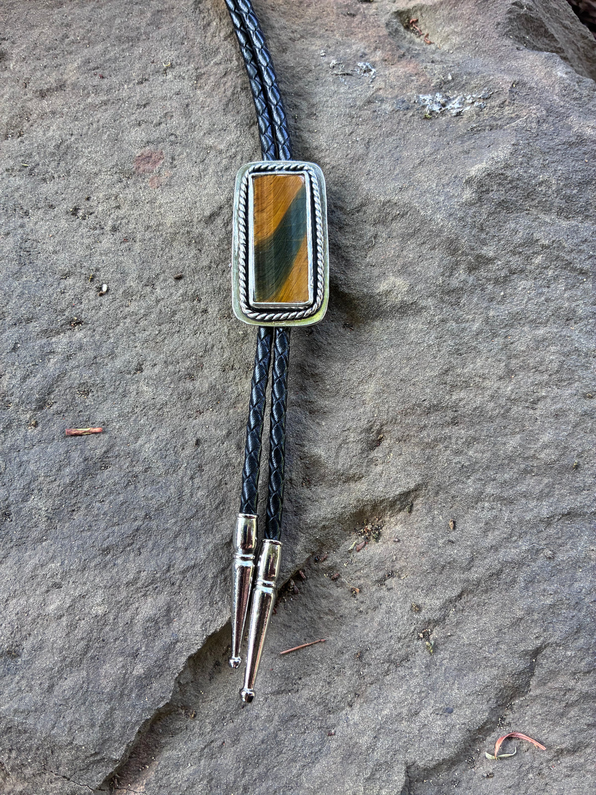 One-of-a-kind Tiger’s Eye bolo tie with black cord and silver-tone tips